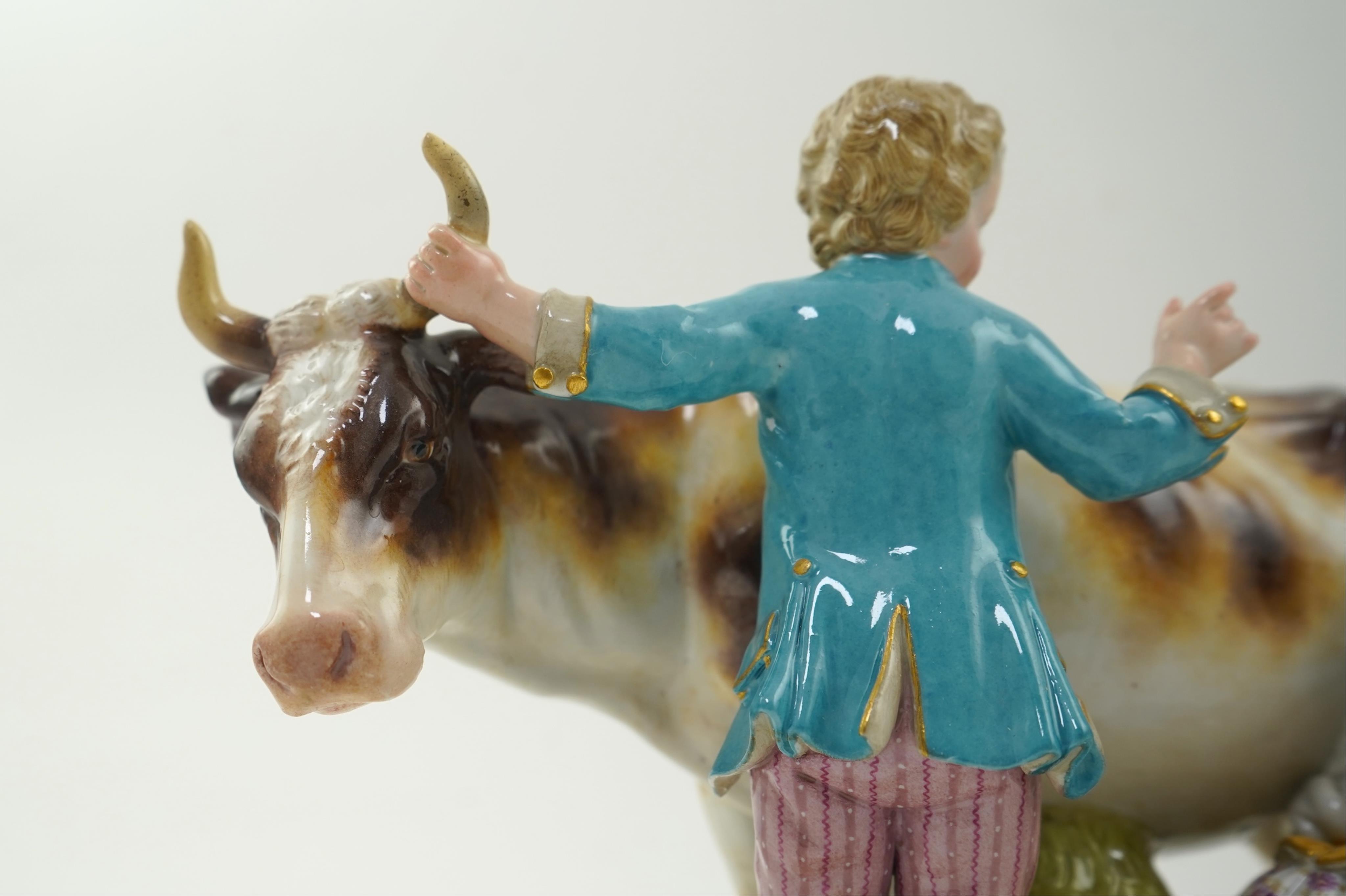 A Meissen group of a boy and girl milking a cow, 19th century